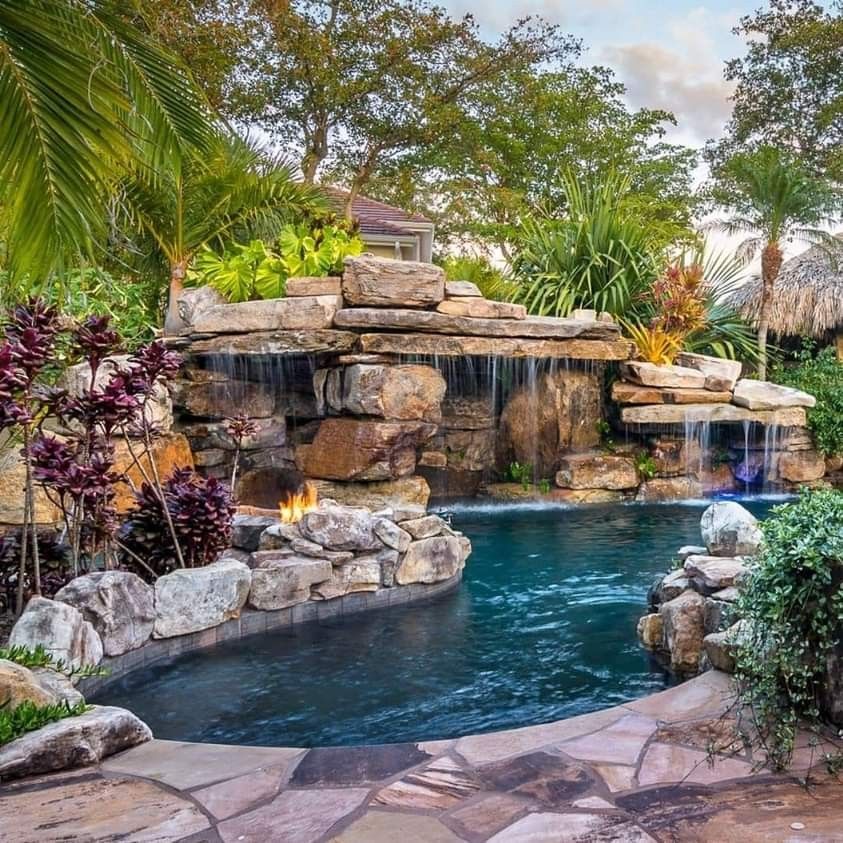 Natural pool with rock waterfall and tropical planting