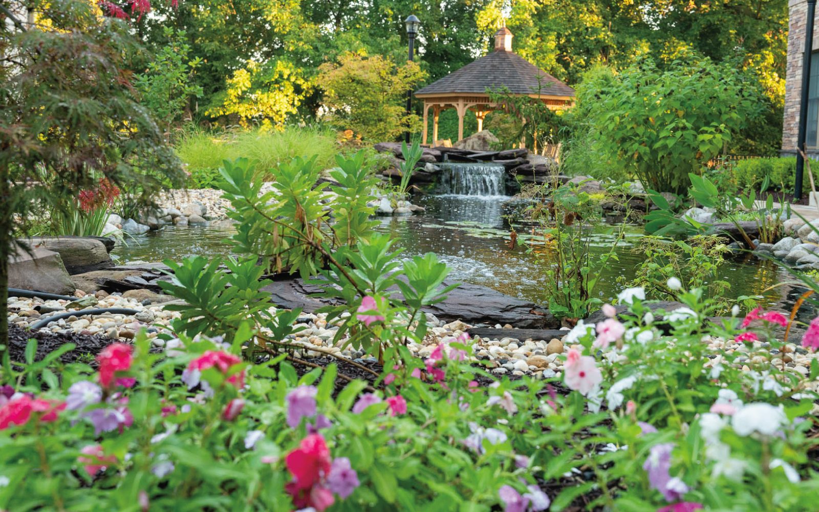 Central garden with pond, waterfall, gazebo and flowering beds