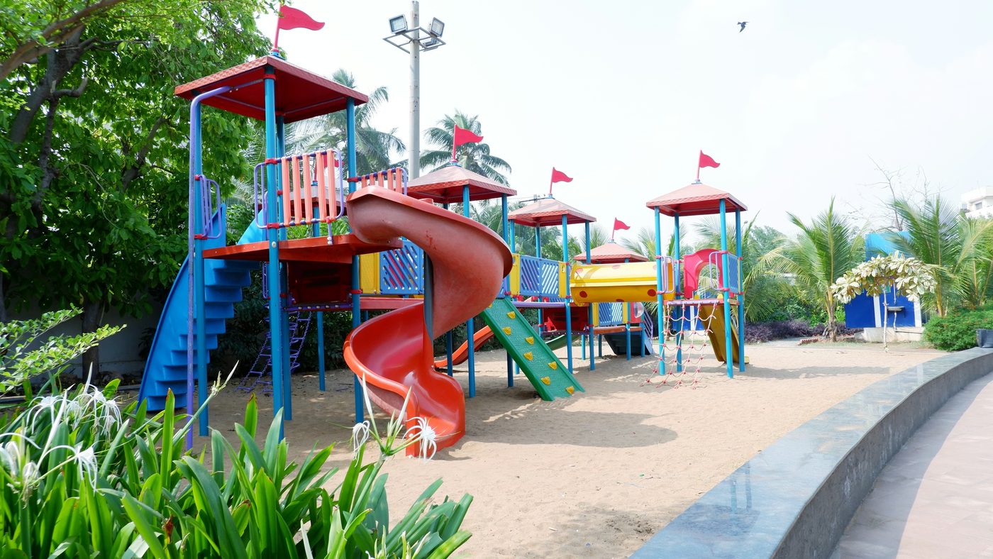 Children's playground with slides, swings and sandy ground